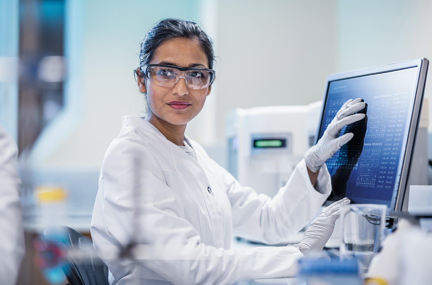 Female Scientist Touching Computer Monitor