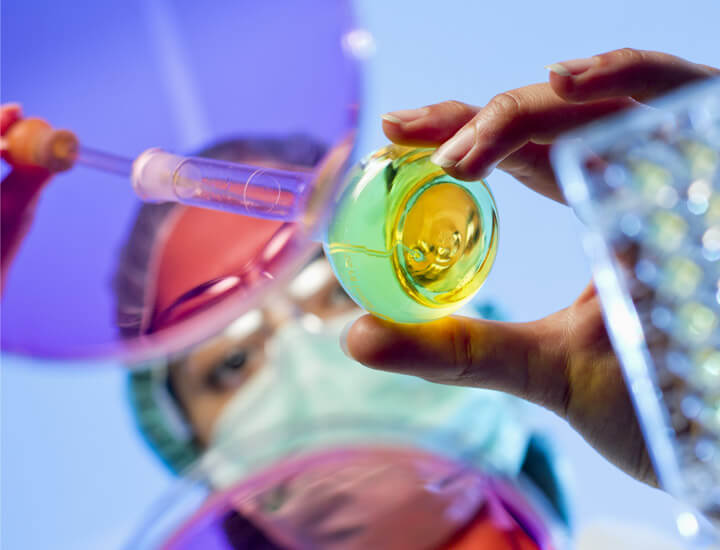 Scientist looking at a petri dish