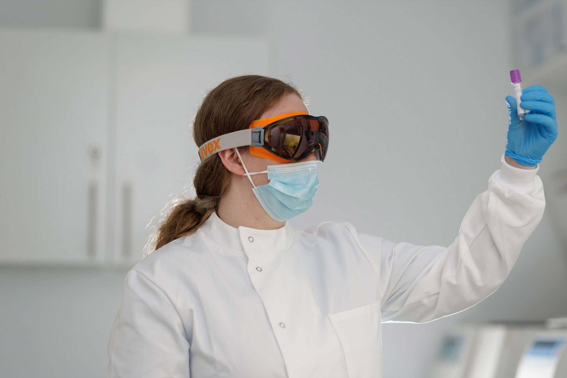 Scientist looking at a test tube